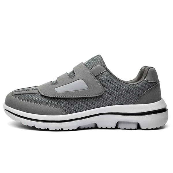 Chaussure de sport grise pour homme, design moderne avec semelle blanche antidérapante. Idéale pour la course et le fitness. Confort et style garantis.