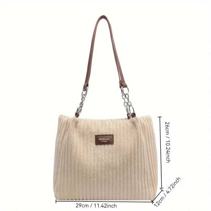 Sac à main beige en velours côtelé avec anses marron, étiquette en cuir, dimensions 29x12x26 cm. Élégant et tendance pour femme.