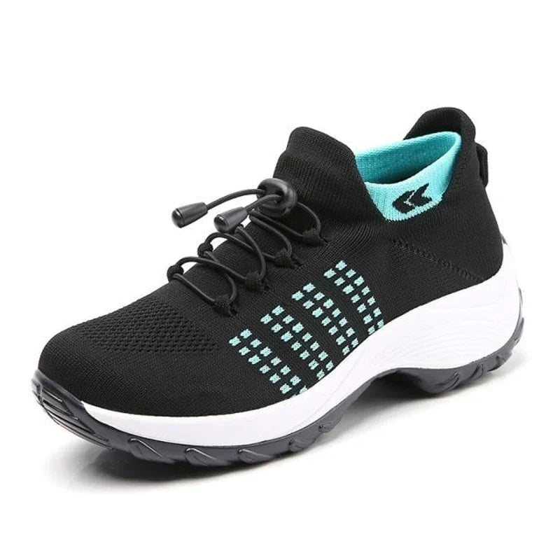 Chaussure de sport noire avec semelle blanche, détails turquoise, lacets élastiques. Idéale pour course à pied, fitness, confort optimal.