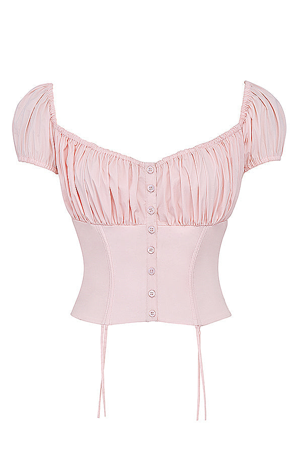 Corset rose pâle à manches bouffantes, boutons décoratifs, style vintage, mode féminine élégante, tendance, vêtement chic et raffiné.