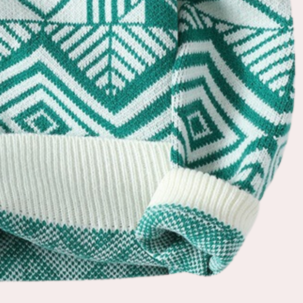 Pull en tricot vert et blanc avec motif géométrique, manches longues, col rond. Mode hiver, style scandinave, tendance vêtements chauds.