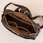 Sac à main en cuir marron avec motif géométrique, ouvert pour montrer l'intérieur spacieux avec plusieurs compartiments, idéal pour organisation.