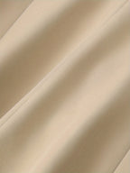 Tissu beige en gros plan, texture douce et plissée, idéal pour la couture et la décoration intérieure. Matériau textile élégant et polyvalent.