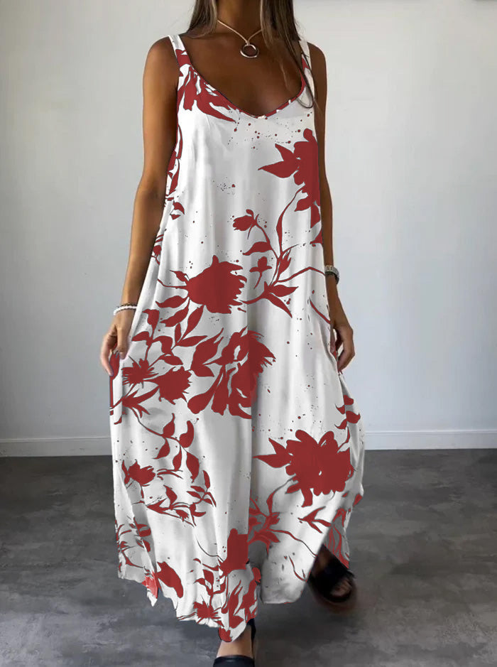 Robe longue d'été blanche à motifs floraux rouges, sans manches, portée par une femme. Style décontracté, idéal pour la saison estivale.