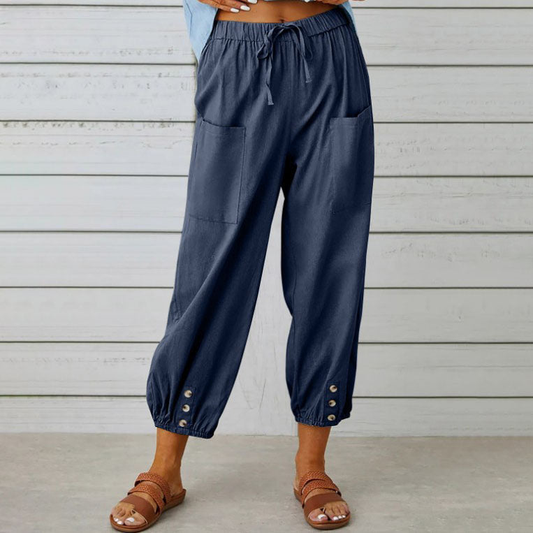 Pantalon ample bleu marine pour femme avec poches avant, boutons décoratifs aux chevilles, style décontracté, idéal pour l'été.