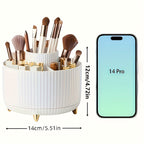 Organisateur de maquillage blanc avec pinceaux, comparé à un smartphone 14 Pro. Dimensions: 14cm de large, 12cm de haut. Accessoire beauté pratique.