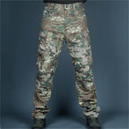 Pantalon camouflage militaire, motif multicolore, poches latérales, style tactique, idéal pour activités extérieures et airsoft.