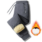 Pantalon d'hiver gris pour homme, doublé en polaire, avec cordon de serrage et motif discret. Idéal pour le froid. Confort et chaleur assurés.
