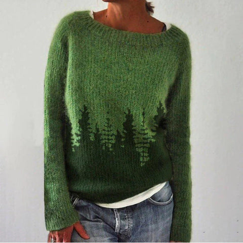 Pull vert en laine avec motif de forêt, manches longues, col rond, porté par une personne. Style décontracté, idéal pour l'automne et l'hiver.