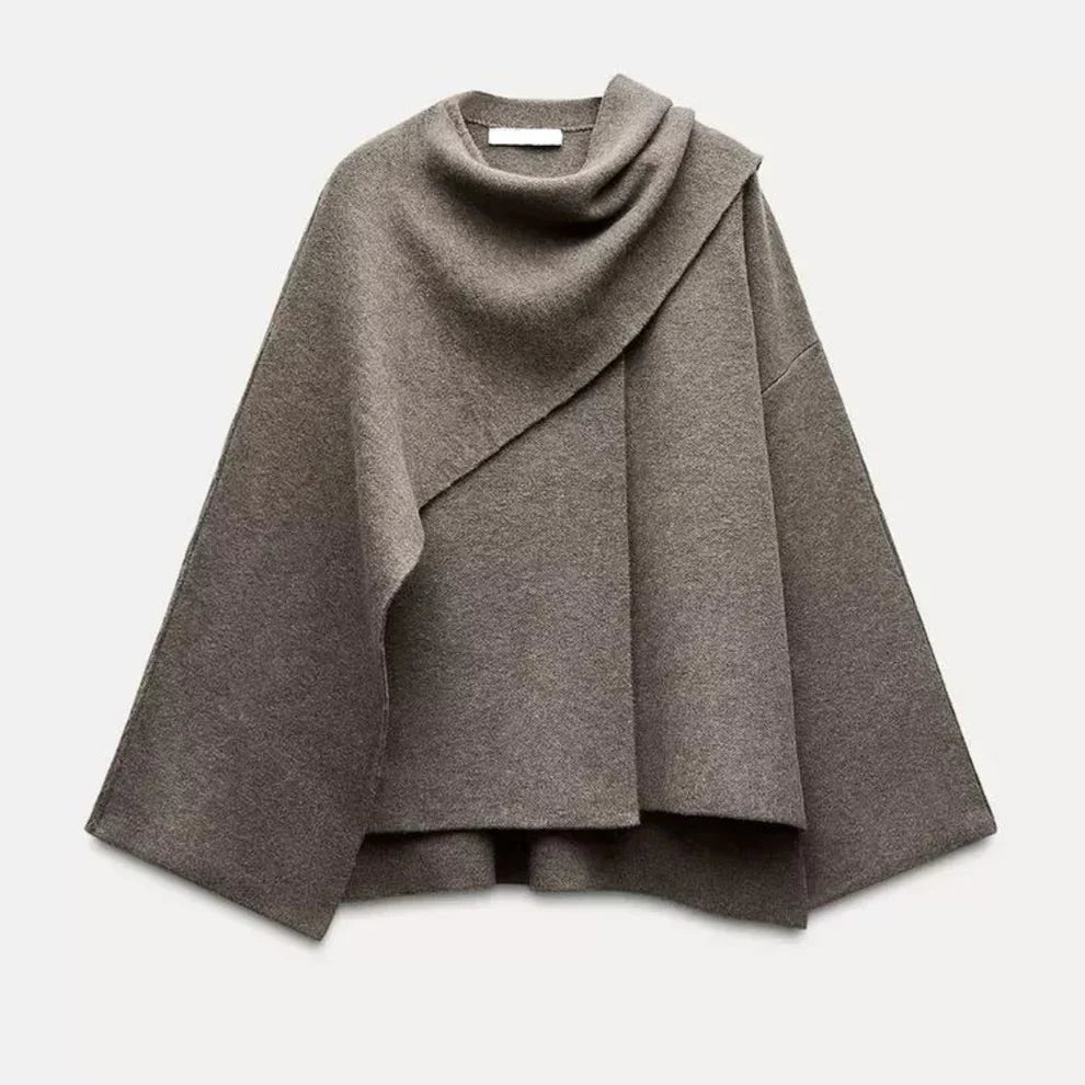Poncho en laine gris, design asymétrique, col drapé, manches larges. Mode automne-hiver, vêtement chaud et élégant pour femmes.