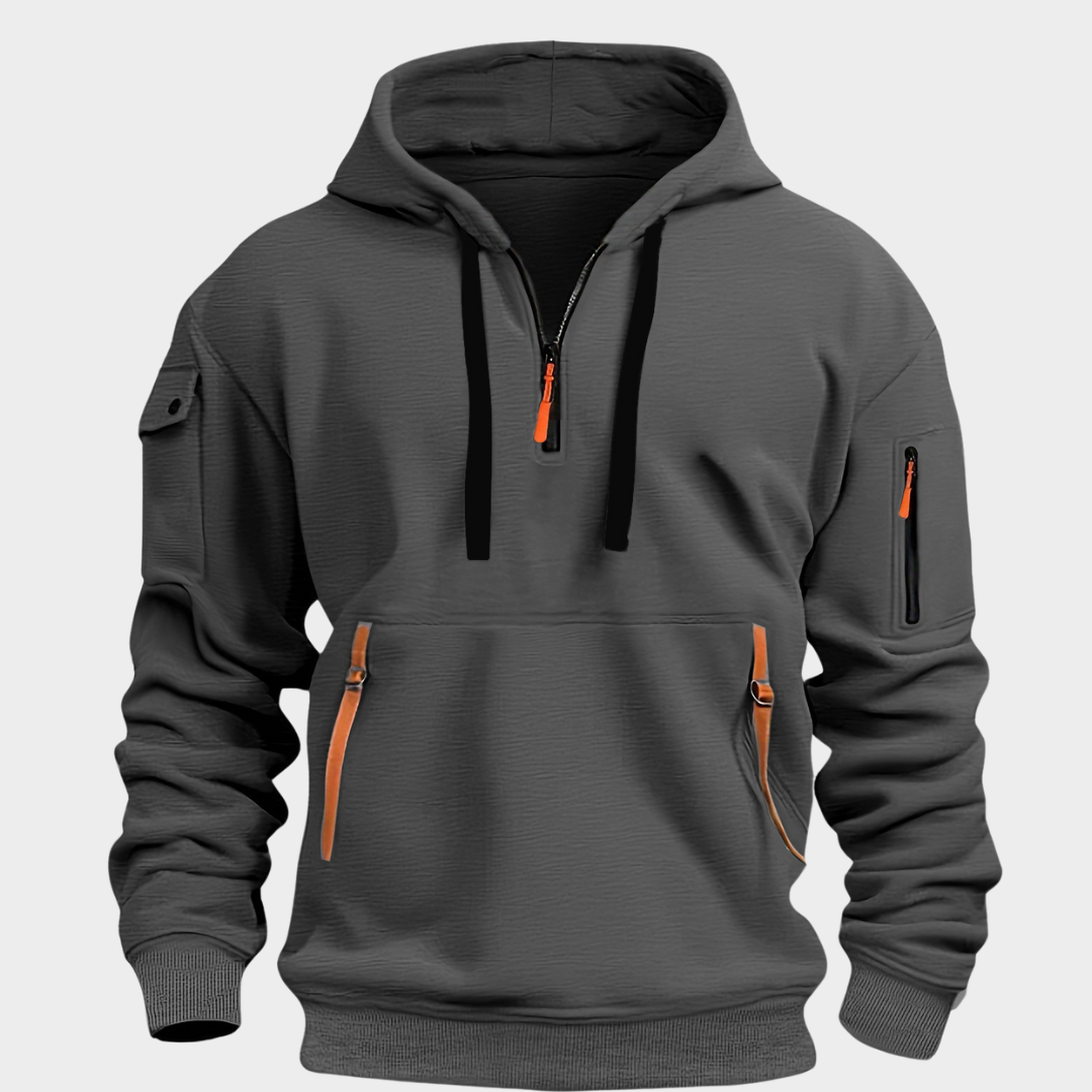 Sweat à capuche gris foncé avec fermeture éclair orange, poches zippées et manches longues. Style décontracté, idéal pour l'automne et l'hiver.