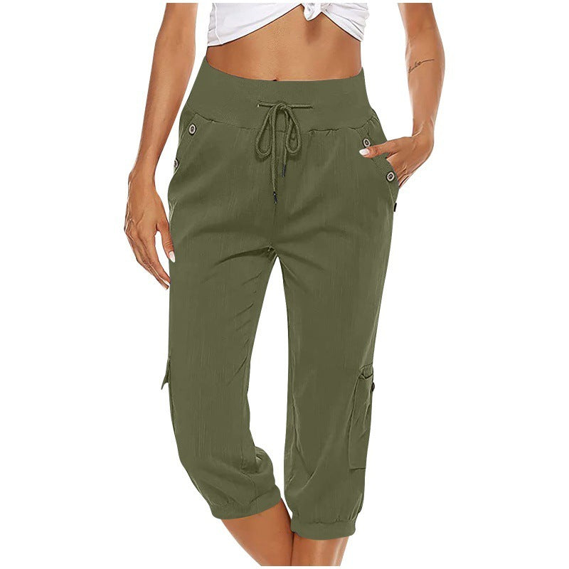 Femme portant un pantalon cargo kaki taille haute avec cordon de serrage, poches latérales et ourlets élastiques, style décontracté et tendance.