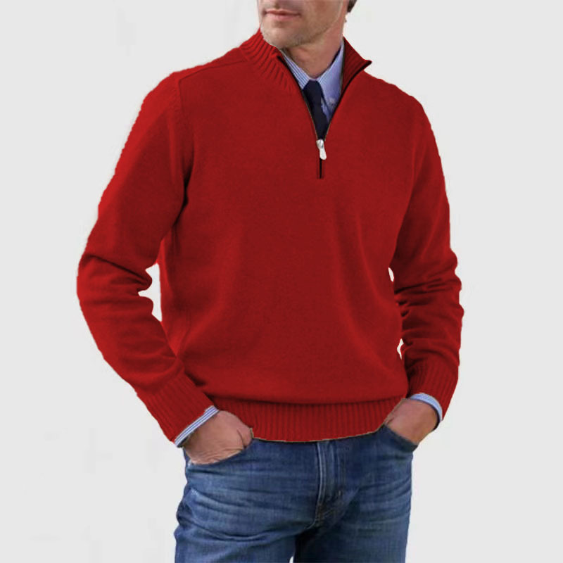 Homme portant un pull rouge à col zippé, chemise bleue et jean. Mode masculine élégante, tenue décontractée chic, style automne-hiver.