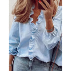 Femme portant une chemise bleue à volants, manches longues, avec un jean. Mode féminine élégante, style décontracté chic, selfie miroir.