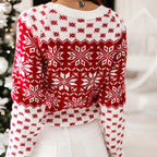 Pull de Noël rouge et blanc avec motifs flocons de neige, femme de dos, ambiance festive, mode hiver, près d'un sapin décoré.