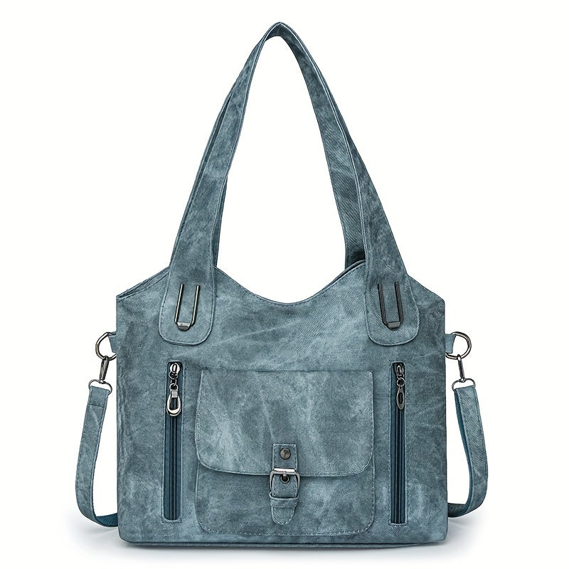 Sac à main en cuir bleu avec bandoulière amovible, poches zippées et boucle avant. Élégant et pratique pour un usage quotidien.