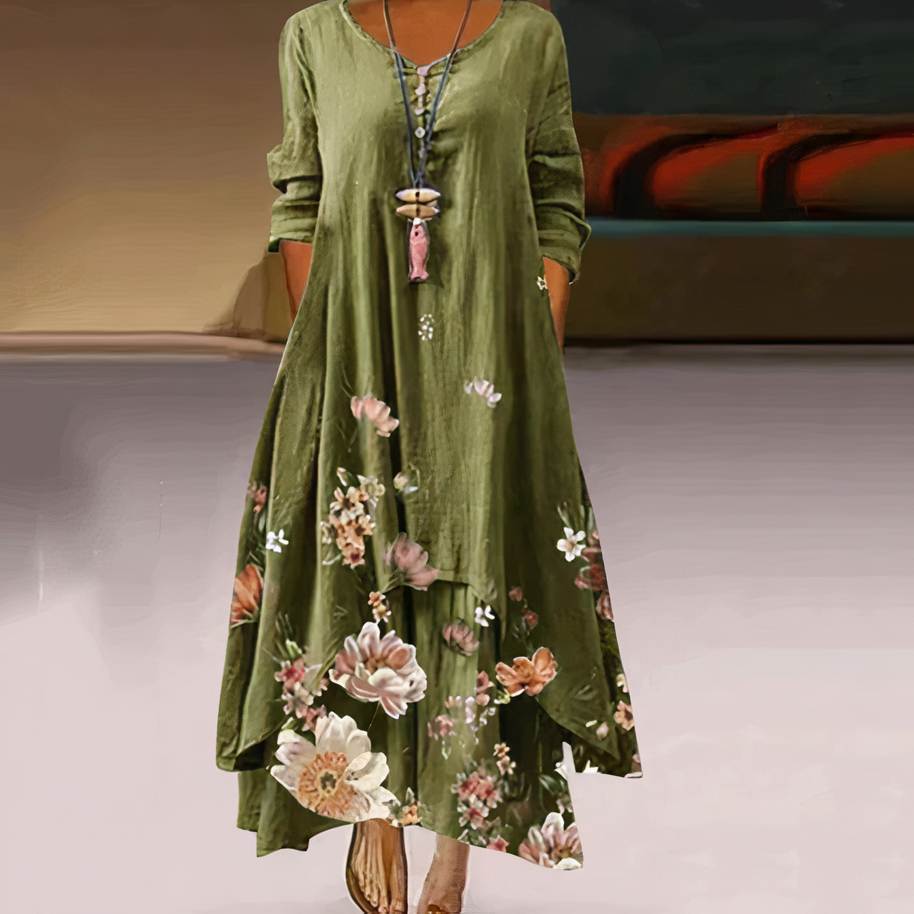 Robe longue verte à manches longues avec motif floral, col lacé, portée par une femme. Mode élégante, style bohème chic, tendance automne.