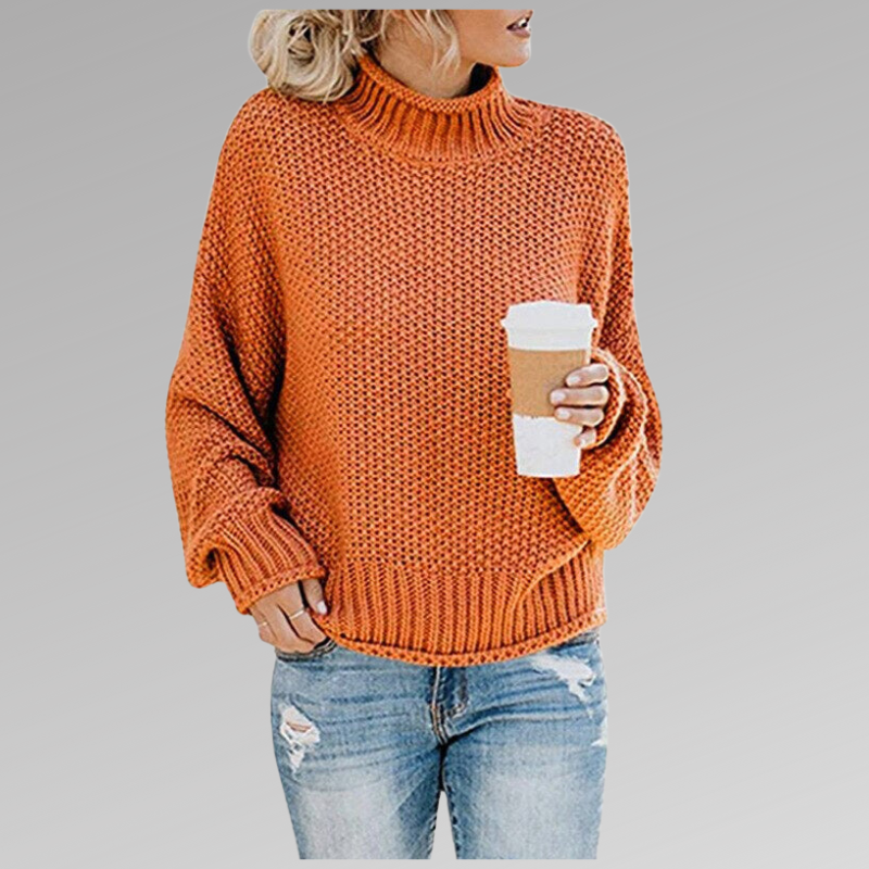 Femme portant un pull orange en tricot avec un col roulé, tenant un café à emporter, vêtue d'un jean déchiré. Mode automne, style décontracté.