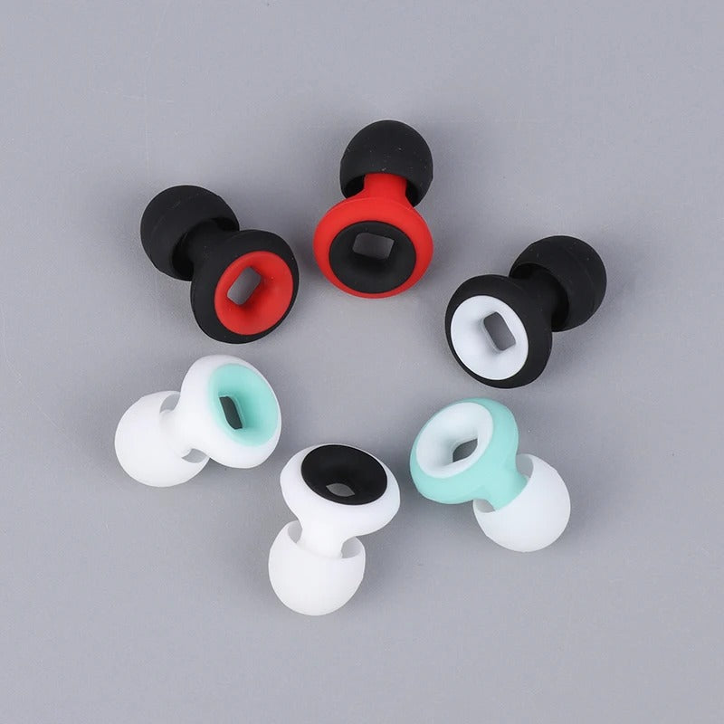 Boucles d'oreilles faux écarteurs en silicone multicolores sur fond gris. Accessoires de mode tendance, style punk, bijoux unisexes.