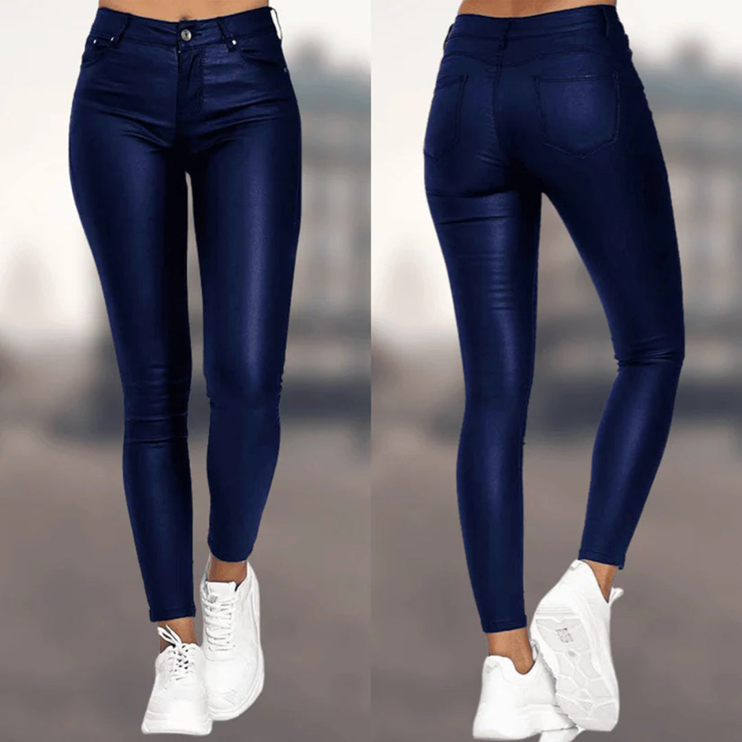 Jean skinny bleu foncé pour femme, vue avant et arrière, avec baskets blanches. Pantalon taille haute, style moderne et tendance.