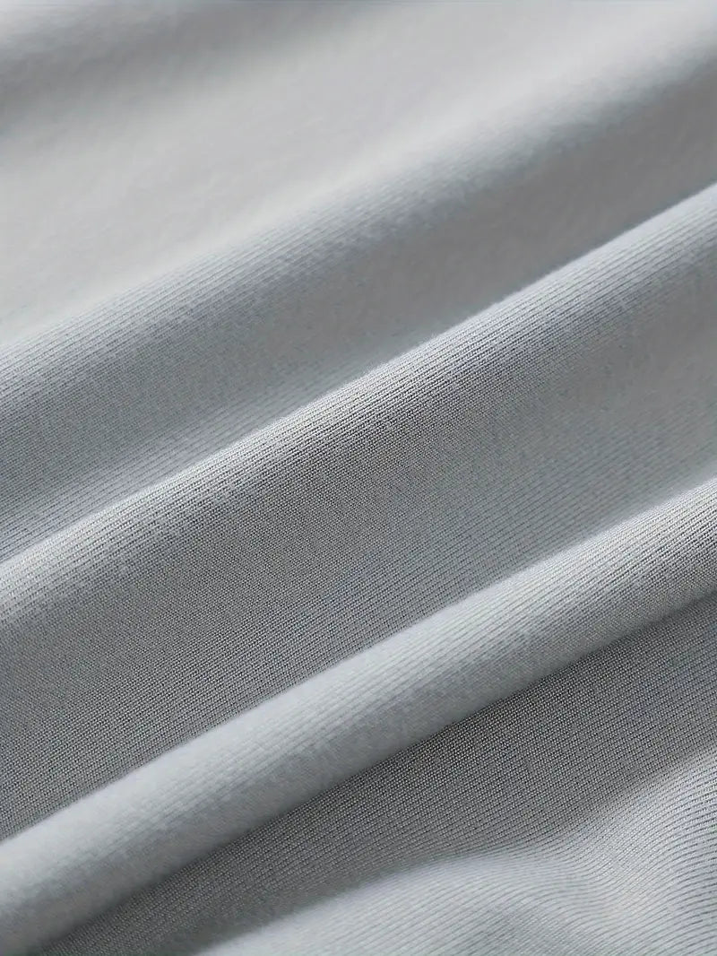 Tissu en coton gris clair, texture douce et lisse, gros plan. Idéal pour vêtements confortables, mode durable, textile de haute qualité.