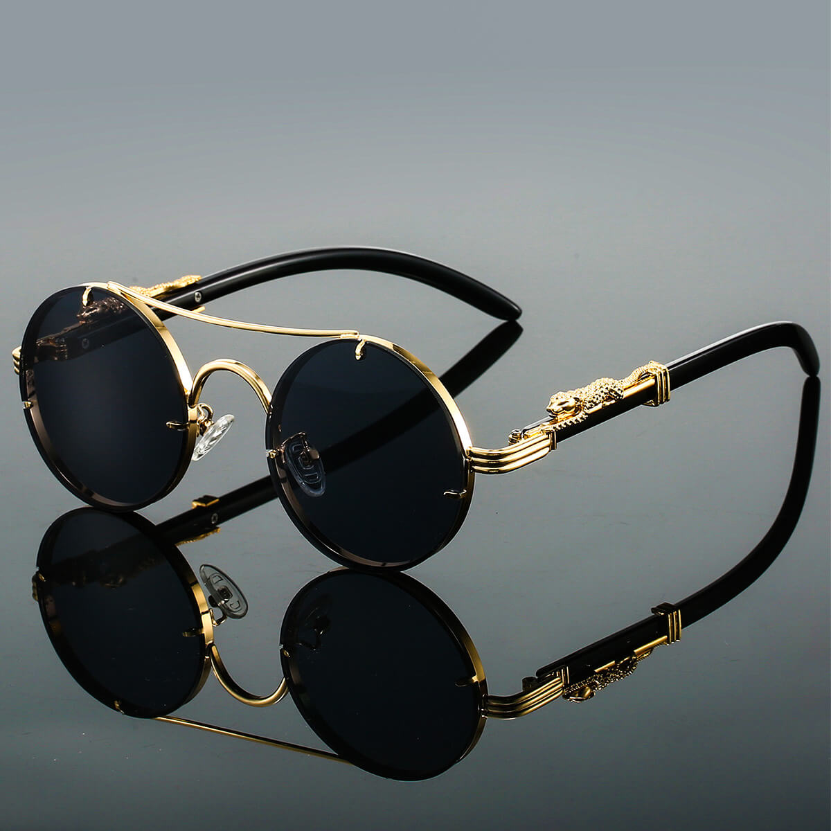 Lunettes de soleil rondes élégantes avec monture dorée et verres noirs, design vintage, accessoires de mode tendance pour homme et femme.
