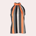 Haut sans manches à col montant, motif rayé et à pois noir, blanc et orange. Mode femme, style rétro chic, tendance printemps-été.