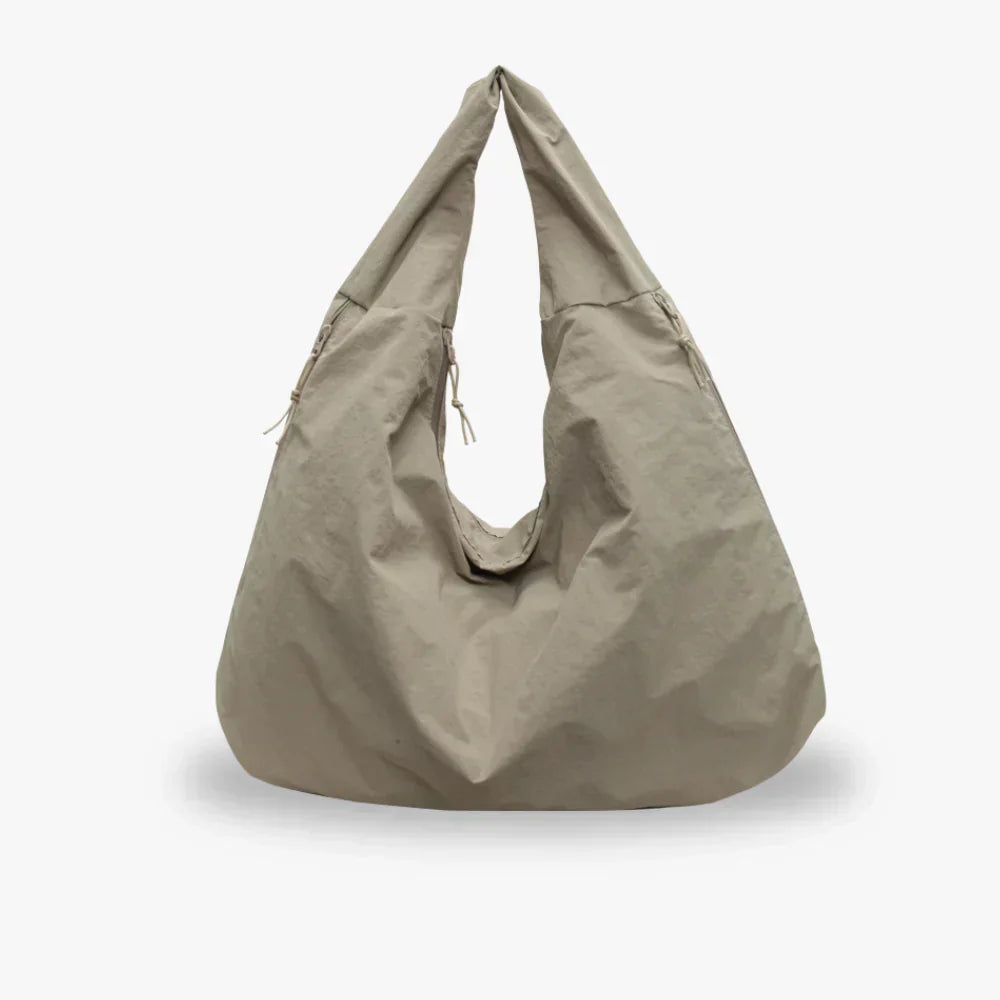 Sac cabas en toile beige, design minimaliste, grande capacité, idéal pour le shopping ou les voyages. Accessoire mode tendance et pratique.