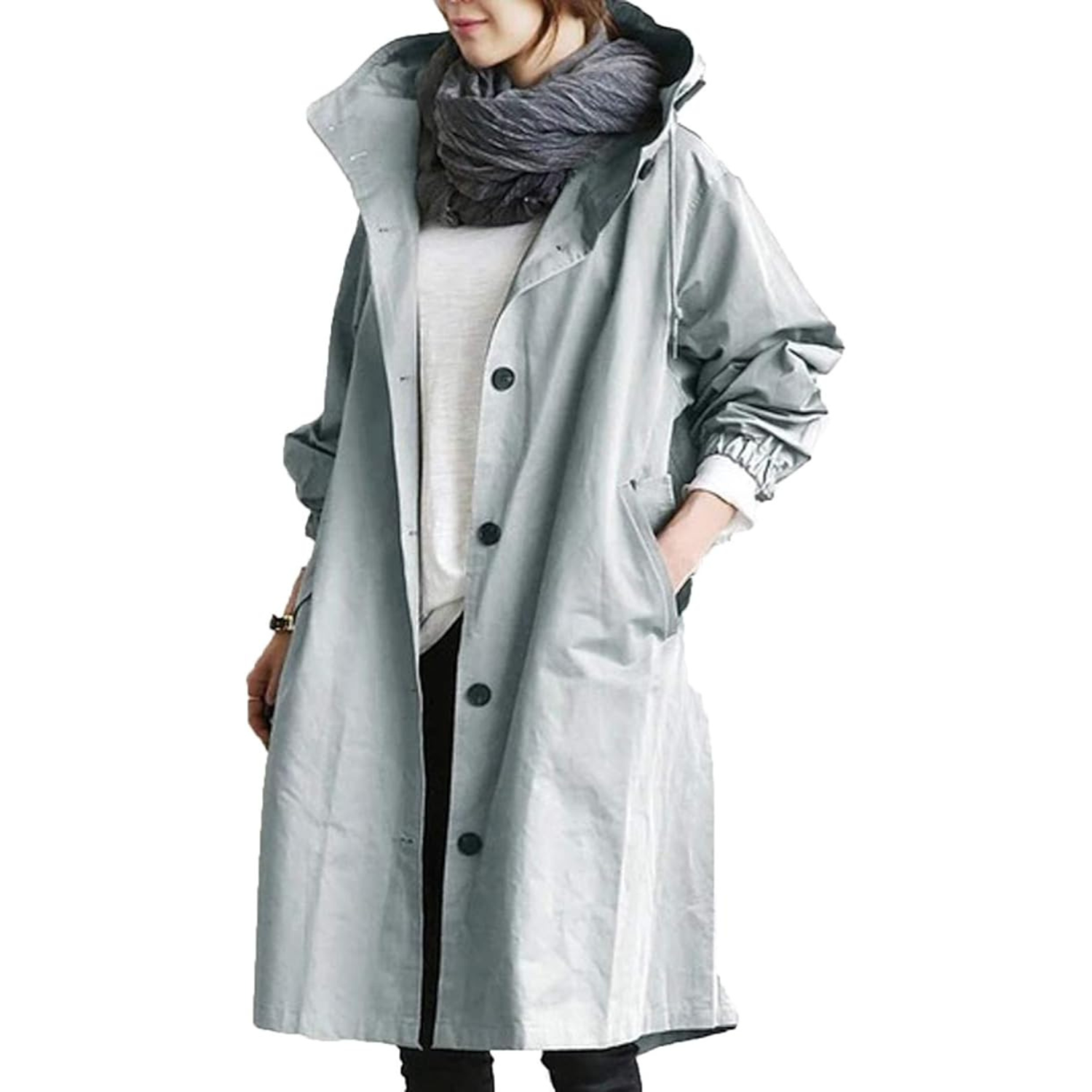 Femme portant un manteau imperméable gris avec écharpe grise, tenue automne-hiver, mode féminine élégante, style décontracté.