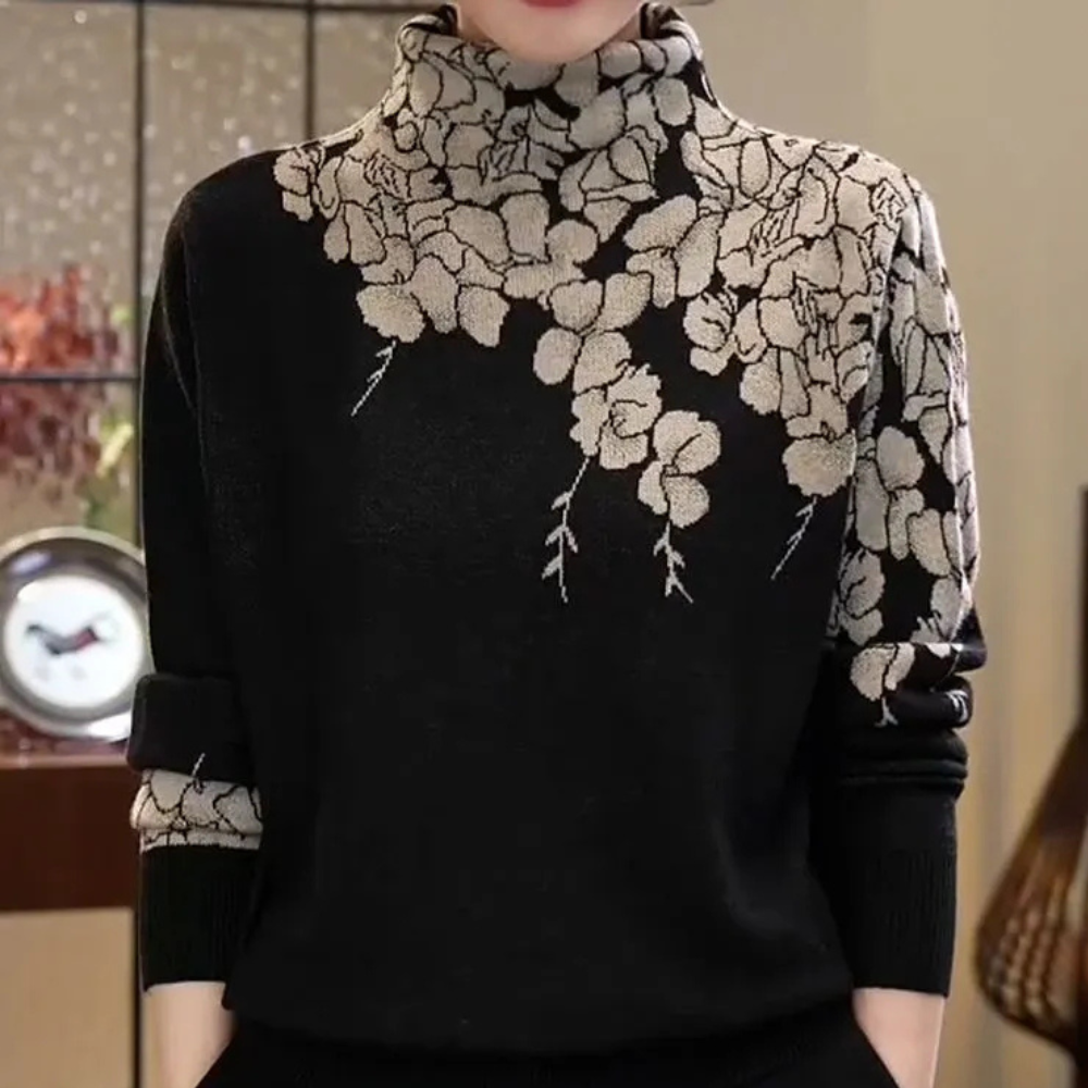Pull noir à col roulé avec motif floral beige, élégant et moderne, idéal pour l'automne. Mode féminine chic, tendance et confortable.