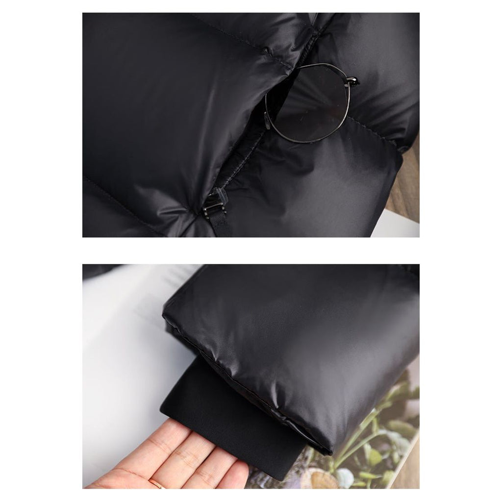 Doudoune noire en tissu matelassé, avec lunettes rondes posées dessus. Manchette élastique visible. Mode hiver, vêtement chaud et élégant.