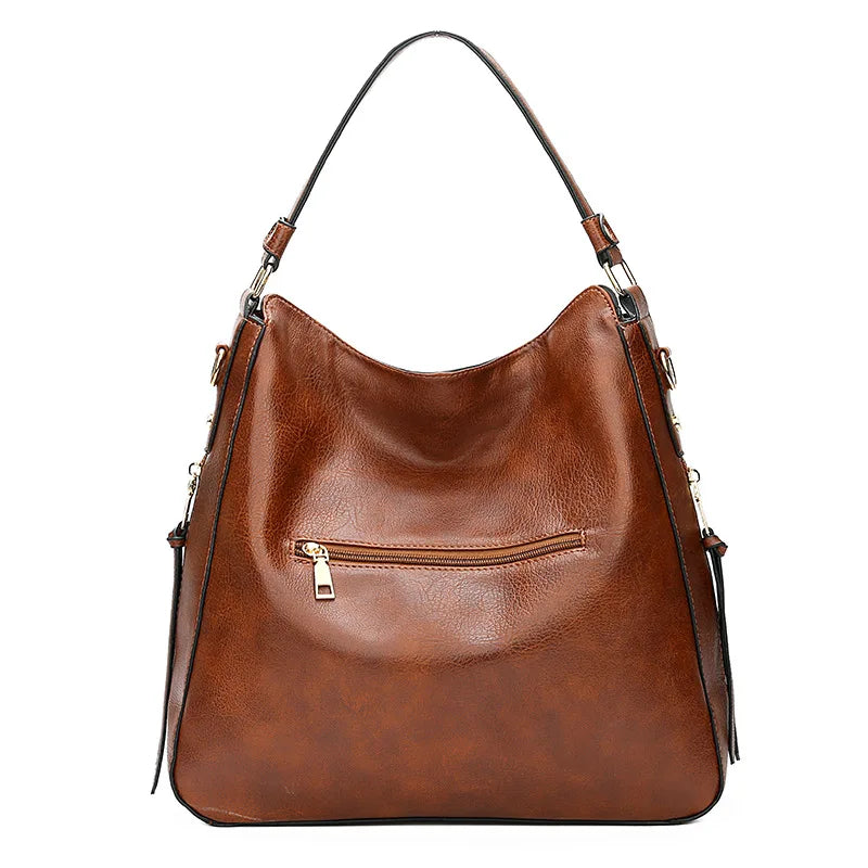 Sac à main en cuir marron avec poche zippée, design élégant et moderne, parfait pour la mode féminine. Accessoire tendance et pratique.