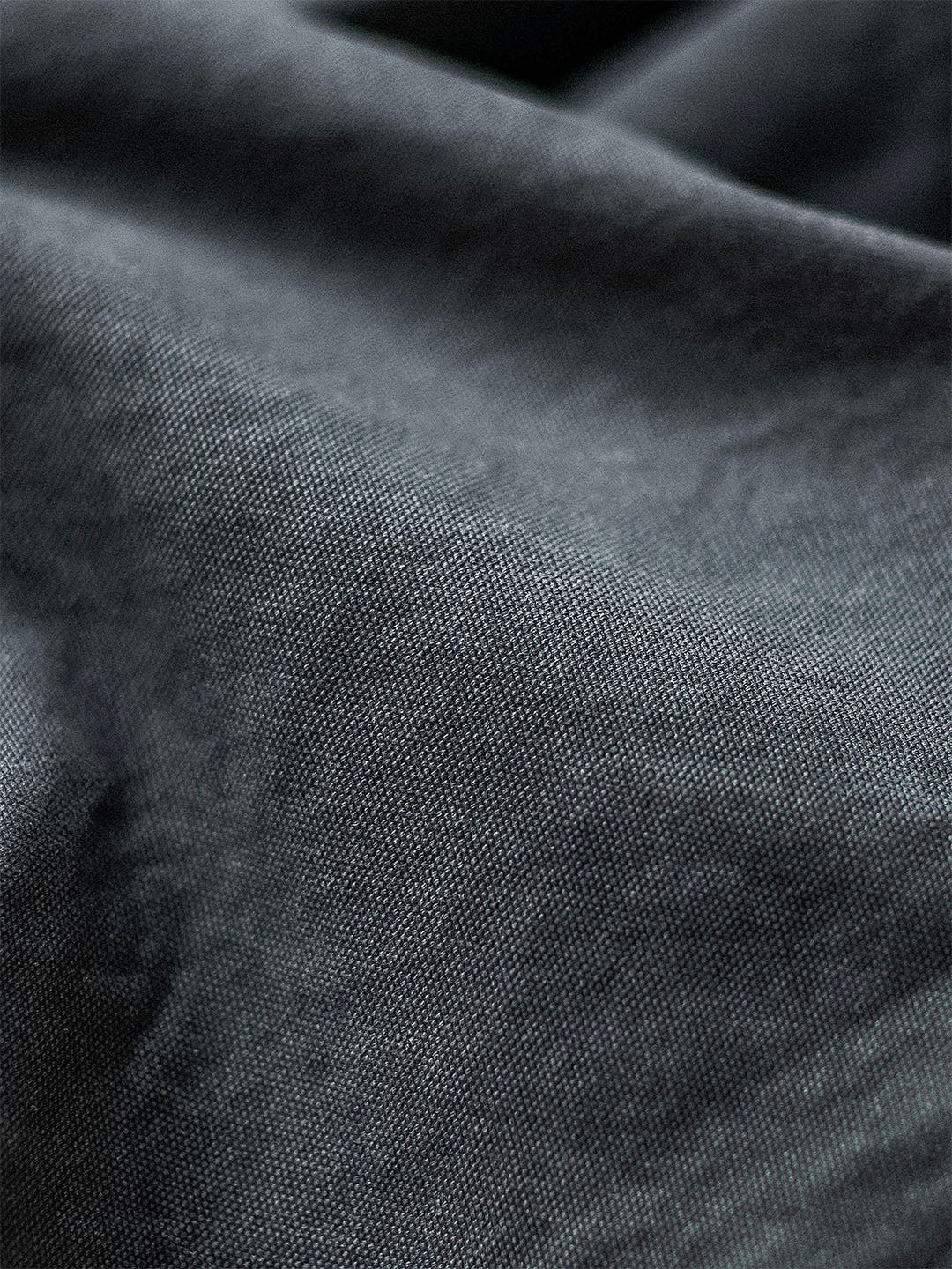Tissu en lin gris foncé, texture douce et naturelle, gros plan. Idéal pour décoration intérieure, mode éco-responsable, textile durable.
