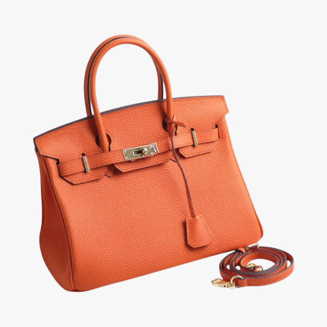 Sac à main en cuir orange de luxe avec bandoulière détachable, design élégant, fermoir doré, idéal pour mode féminine et accessoires tendance.