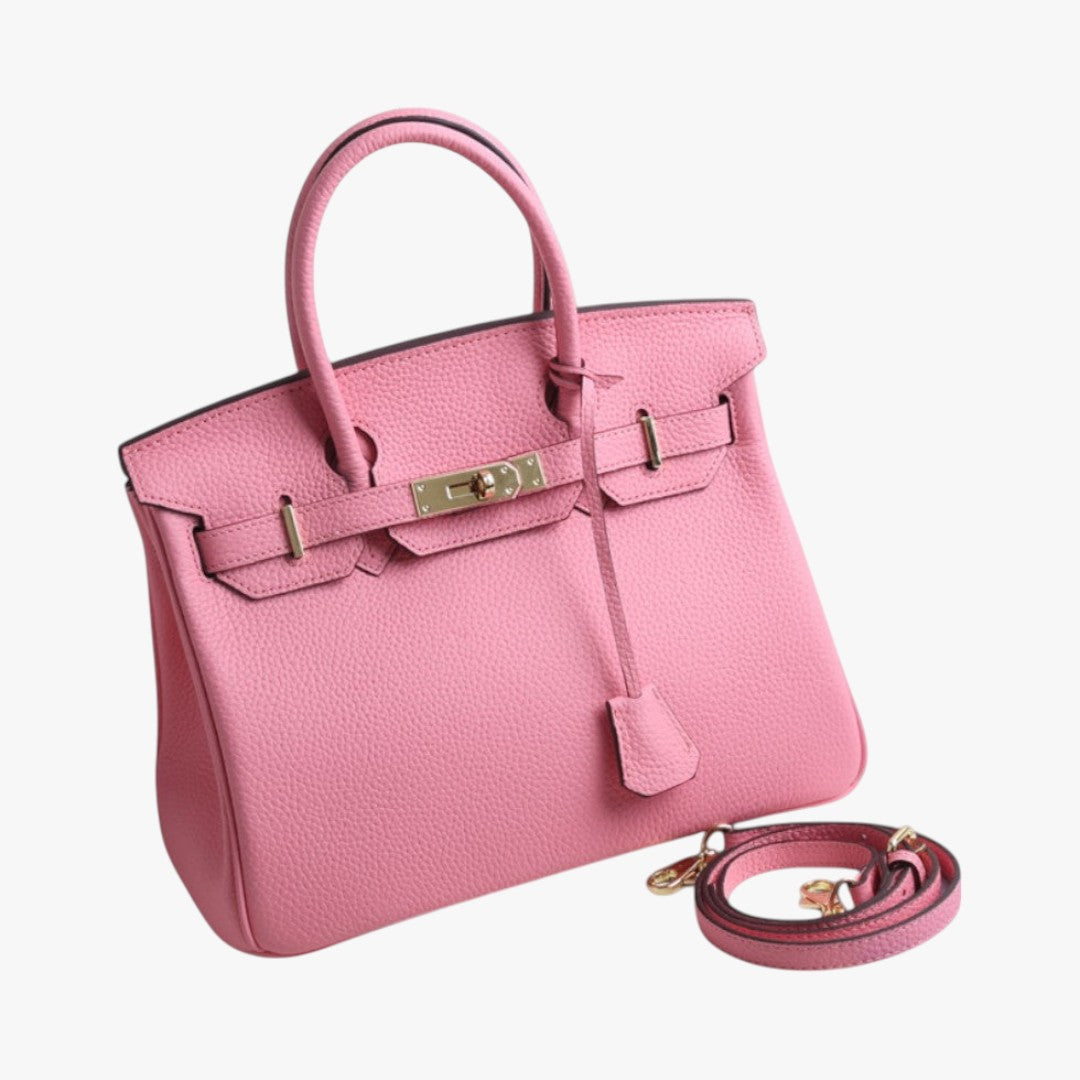 Sac à main rose en cuir avec bandoulière détachable, fermoir doré. Élégant et tendance, idéal pour la mode féminine. Accessoire chic.