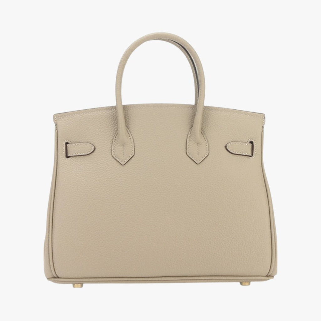Sac à main beige en cuir texturé, style Birkin, avec poignées doubles et pieds métalliques dorés. Accessoire de mode élégant et luxueux.
