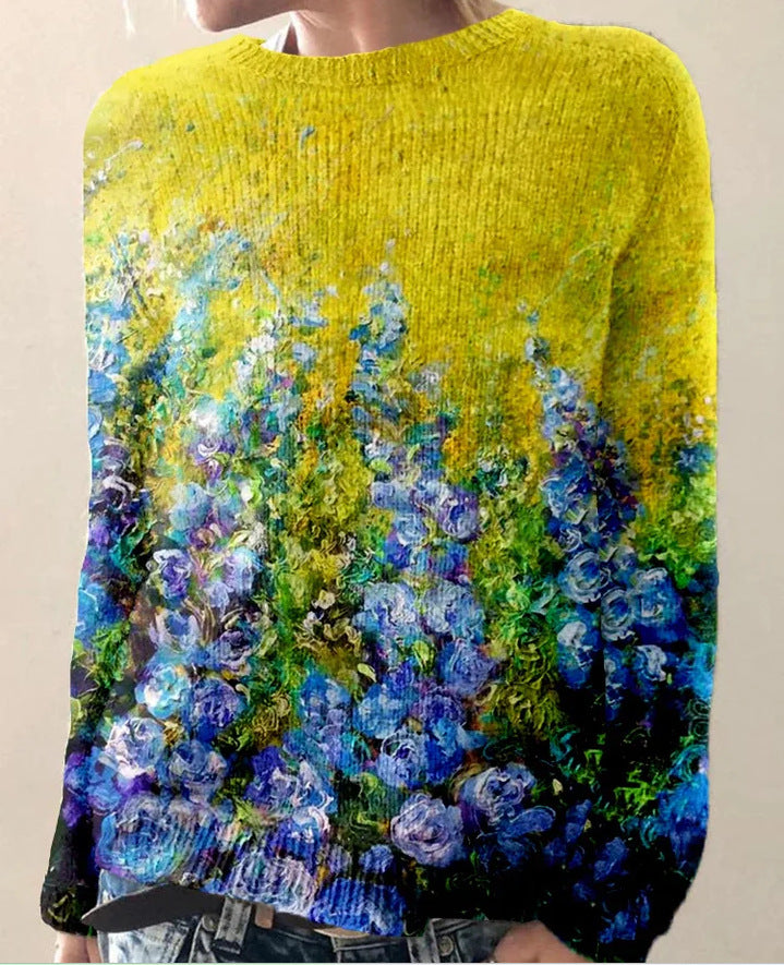 Pull en laine jaune avec motif floral bleu et violet, style artistique. Mode automne-hiver, vêtement tendance, design unique et coloré.