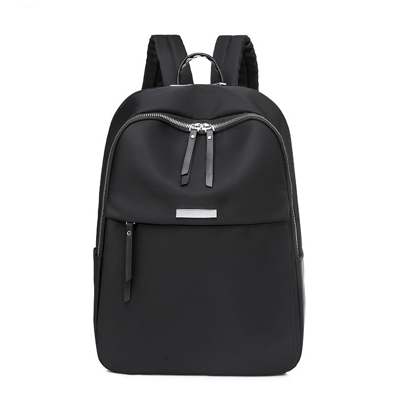 Sac à dos noir élégant avec fermeture éclair argentée, design moderne et minimaliste, idéal pour le voyage, l'école ou le travail.