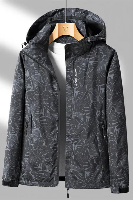 Veste imperméable noire à motifs feuillage, capuche ajustable, fermeture éclair, idéale pour activités extérieures, randonnée, mode automne-hiver.