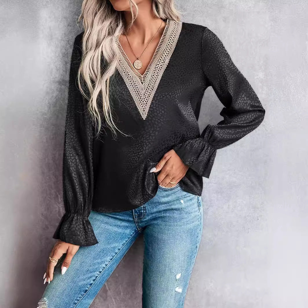 Femme portant un chemisier noir à manches longues avec dentelle, associé à un jean bleu déchiré. Mode élégante, tenue décontractée chic.