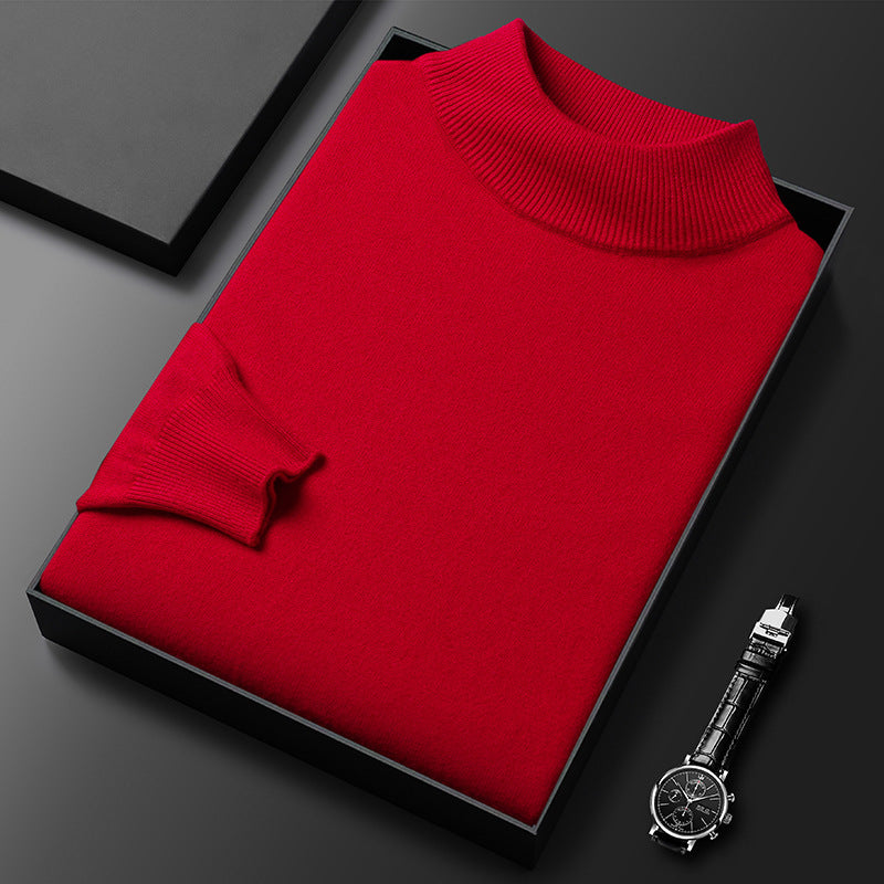 Pull-over rouge en laine plié dans une boîte noire, accompagné d'une montre-bracelet élégante. Mode hiver, vêtements chauds, accessoires de luxe.