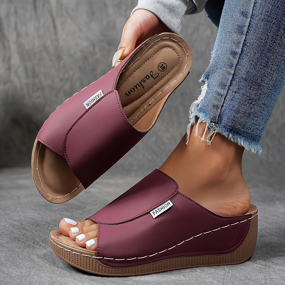 Sandales compensées bordeaux pour femme, design moderne, confortables, portées avec un jean décontracté. Mode estivale, tendance chaussures 2023.