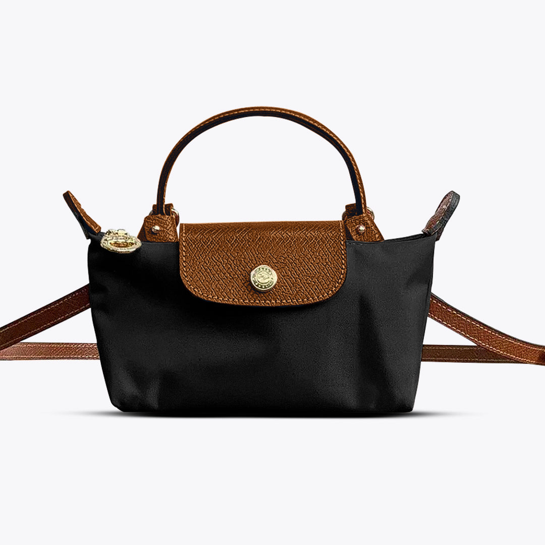 Sac à main noir et marron en cuir, design élégant avec bandoulière ajustable, idéal pour la mode féminine. Accessoire tendance et pratique.