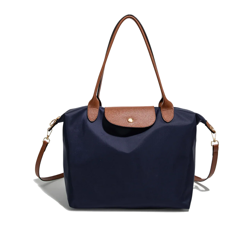 Sac à main bleu marine avec poignées et rabat en cuir marron, design élégant et pratique, idéal pour la mode féminine et le quotidien.