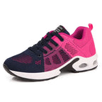 Baskets de sport femme, bleu et rose, semelle épaisse, design respirant, lacets noirs, idéales pour course à pied et fitness.