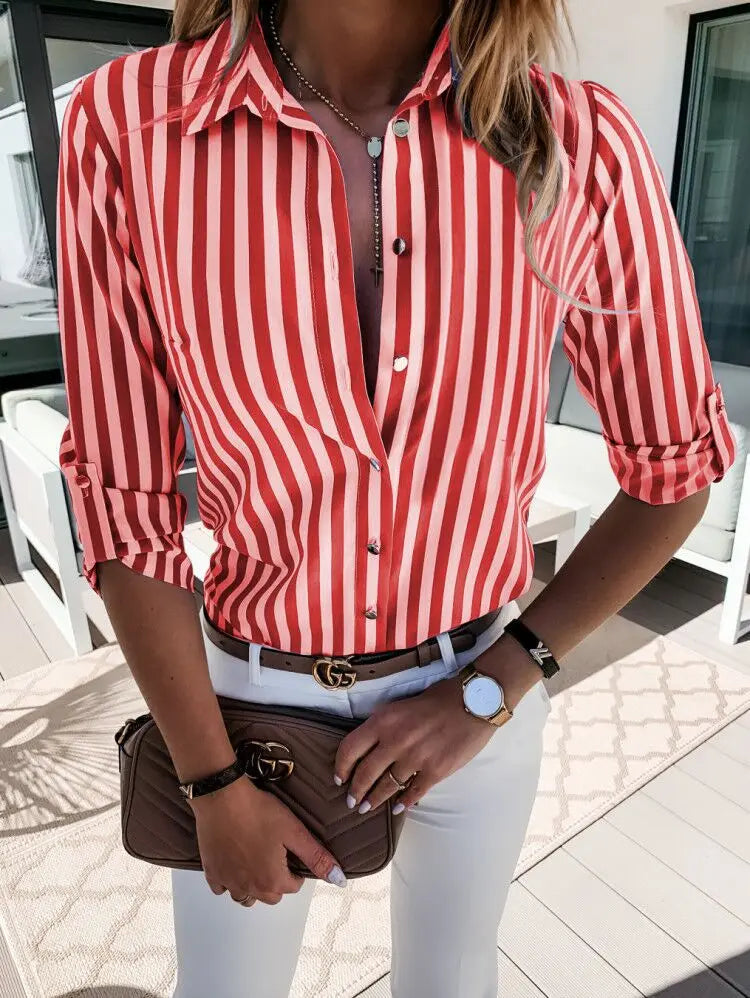 Femme portant une chemise à rayures rouges et blanches, pantalon blanc, montre élégante, ceinture noire et sac à main marron, style chic et moderne.