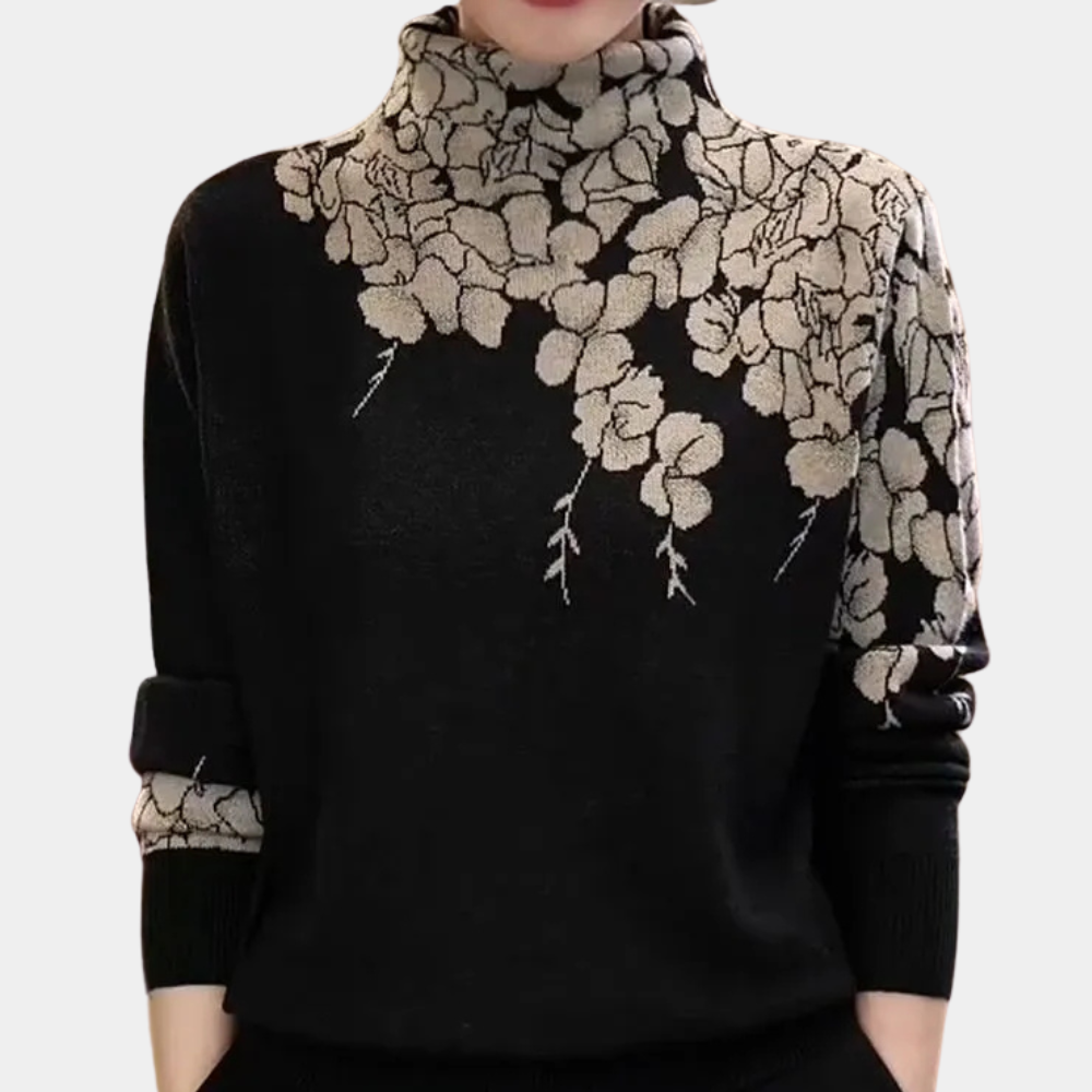 Pull noir à col roulé avec motif floral beige, manches longues. Élégant et tendance, idéal pour l'automne et l'hiver. Mode féminine chic.