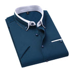 Chemise homme bleu marine élégante, col blanc contrasté, boutons assortis, poche poitrine, style formel, mode masculine, vêtement tendance.