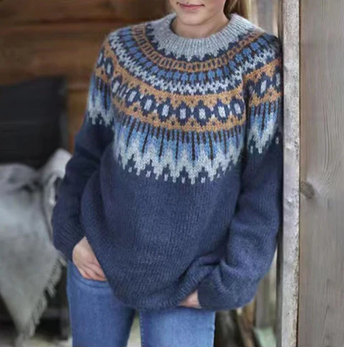 Pull en laine bleu avec motif nordique, manches longues, porté par une personne debout. Mode hiver, tricot chaud, style scandinave.