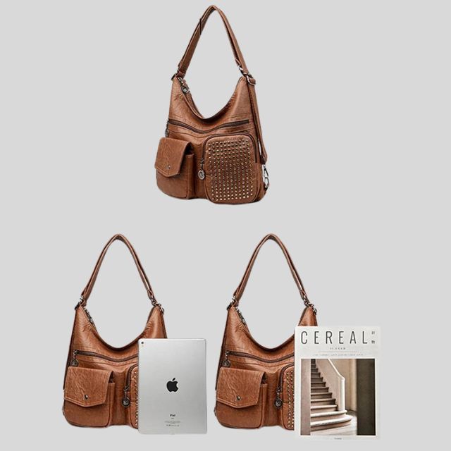 Sac à main en cuir marron avec poches zippées et cloutées, accompagné d'un iPad et d'un magazine, mode femme, accessoires tendance.